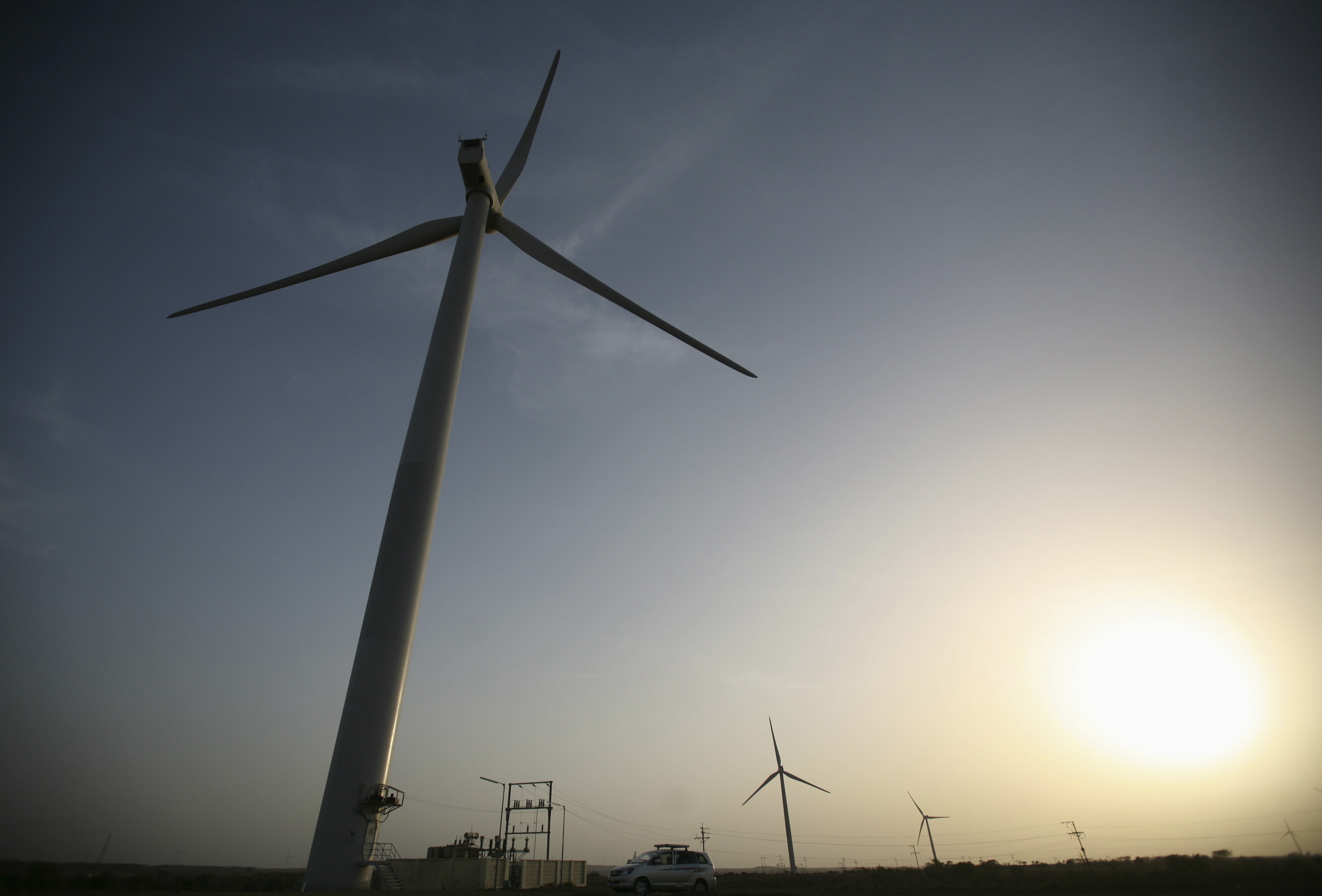 Power generating windmill turbines are pictured during the inauguration ceremony of the new 25 MW ReNew Power wind farm at Kalasar village in the western Indian state of Gujarat May 6, 2012. REUTERS/Amit Dave (INDIA - Tags: ENERGY BUSINESS) - GM1E85700TW02