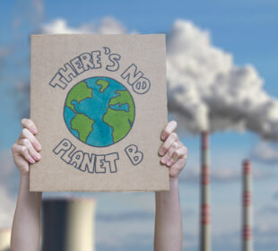 A protestor holds up a sign to protest climate change, which says: There is no Planet B